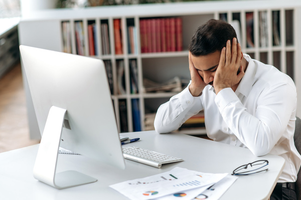 IT manager working reactively dealing with IT support issues in an office